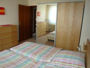 a bedroom with a bed and a large mirror at Ferienwohnung S und K Bremerhaven in Bremerhaven
