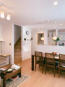 a living room and dining room with a table and chairs at Uhome Ikebukuro Villa 2 in Tokyo