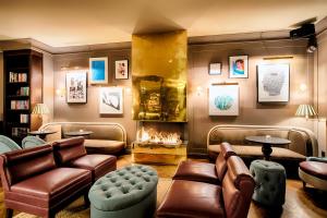 a living room with a couch and a fireplace at Mondrian Suites Berlin am Checkpoint Charlie in Berlin