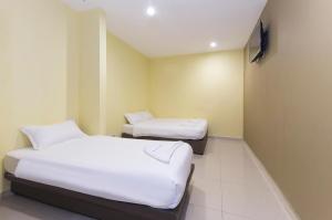 Postel nebo postele na pokoji v ubytování Hotel Raja Bot