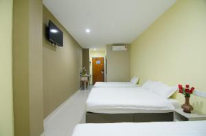 Postel nebo postele na pokoji v ubytování Hotel Raja Bot