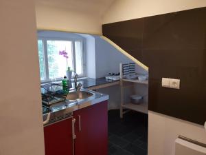 Una pequeña cocina con fregadero y ventana. en Kudamm Apartments, en Berlín 47 fotos más