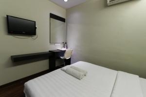 Voodi või voodid majutusasutuse Hotel 99 Bandar Klang (Meru) toas