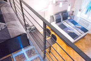 Una habitación tipo loft con una cama y un sofá. en Kudamm Apartments, en Berlín