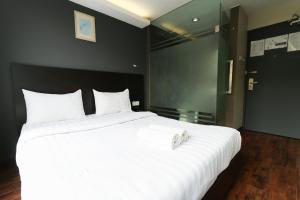 Voodi või voodid majutusasutuse Hotel 99 Bandar Klang (Meru) toas