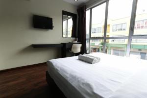 Voodi või voodid majutusasutuse Hotel 99 Bandar Klang (Meru) toas