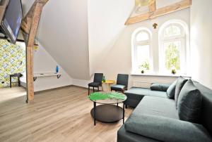 a living room with a couch and a table at Grand Apartments - Superior Loft Apartment in Sopot