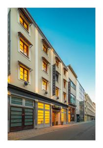 a building with yellow doors on a city street at Trip Inn Eden Antwerpen in Antwerp