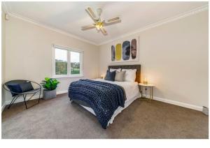 a bedroom with a bed and a ceiling fan at Gracemont Boutique Accommodation in Healesville