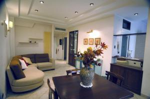 a living room with a vase of flowers on a table at Roma Chic House in Rome