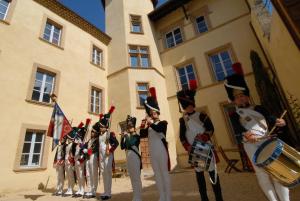 a group of soldiers in uniform standing in front of a building at Maison de la Pra in Valence