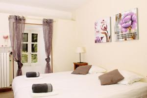 a bedroom with two beds and a window at Auberge Le Romarin in Valgorge