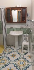 a bathroom with a sink and a floor with a flower pattern at Dimora Corte antica in Scorrano +20 photos