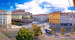 a city street with buildings and a bus at Seven Stories Rooms, 4th Floor, no elevator in Zagreb