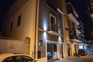 a car parked in front of a building at night at InCentro B&B in Milazzo