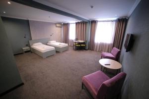 Tempat tidur dalam kamar di Olympica Hotel