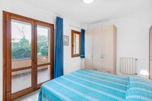 a bedroom with a bed and a large window at Cassiopea in Marina di Campo