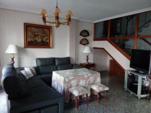 a living room with a couch and a staircase at Casa Turistica Termas aparcamiento y desayuno incluido in Merida
