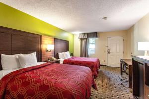 a hotel room with two beds and a desk at Econo Lodge Russellville in Russellville