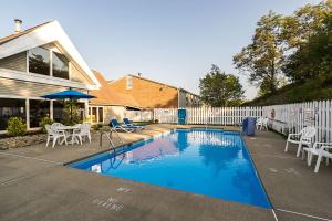 a swimming pool in front of a house at Quality Inn in Morgantown