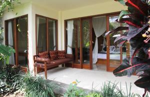 a chair sitting on the porch of a house at Sapodilla Ubud in Ubud