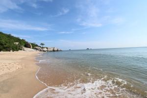 a sandy beach with rocks in the water at T Villas Hua Hin in Khao Tao