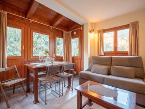 a living room with a couch and a table at SOLDEU cosy home in Soldeu