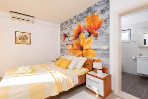 a bedroom with a bed and a brick wall at Apartments Lenka in Orebić