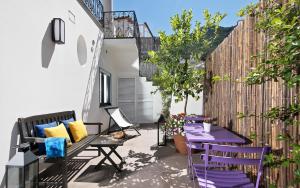 a patio with purple chairs and a purple bench at Lulù Capri in Anacapri