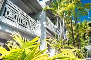 a building with palm trees in front of it at The Palms Resort in Saint James