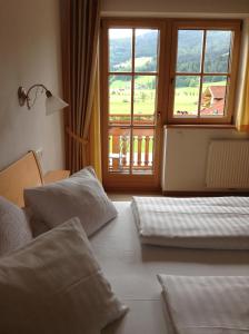 a hotel room with two beds and a window at Taurachblick in Radstadt