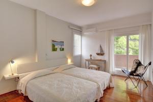 A bed or beds in a room at Villa Loutraki Sunset
