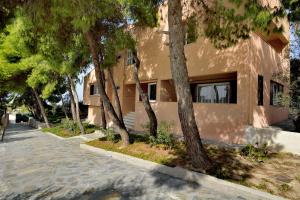 a building with trees in front of it at Villa Loutraki Sunset in Loutraki