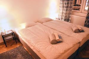 a bedroom with a bed with two towels on it at HILLS Apartments in Vršac
