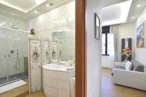 a bathroom with a sink and a shower at Caserta Deluxe in Caserta +37 photos