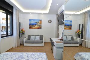 a living room with a couch and a table at Caserta Deluxe in Caserta