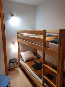 two bunk beds in a room with a lamp at Appartement 3 pièces 6 personnes, Le Panoramique, La Joue du loup in La Joue du Loup