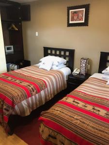 A bed or beds in a room at Cusco Bed and Breakfast