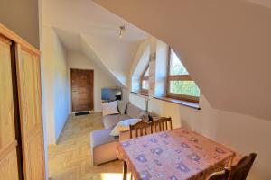 a living room with a couch and a table at Agroturystyka Podzamcze in Krzeszowice