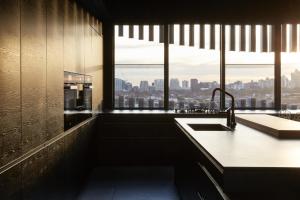 a kitchen with a sink and a large window at Birdcage Penthouse Luxury Melbourne Ultra Modern Industrial Chic in Melbourne