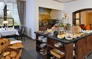 a breakfast buffet in a hotel with bread and food at Hotel Spiegel in Cologne
