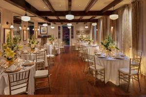 a banquet hall with white tables and chairs and flowers at Hotel Provincial in New Orleans