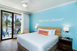 a bedroom with a bed with a blue wall at Margaritaville Beach Resort Playa Flamingo in Playa Flamingo