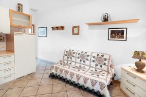 a living room with a couch in a kitchen at Golfo 4 in Marina di Campo