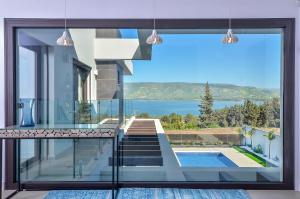 a house with a view of a swimming pool at פרימור סוויטות יוקרה Primor Deluxe Suits in Kinneret