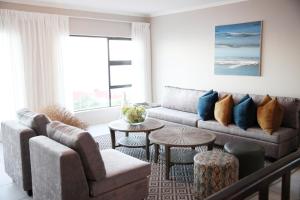 a living room with a couch and a table at Eden Guesthouse B&B in Dana Bay