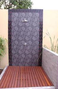 a shower with a black and white patterned wall at Sakorn Residence and Hotel in Chiang Mai