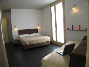 a hotel room with two beds and a laptop computer at 6 Porte Guesthouse in Mantova +45 photos