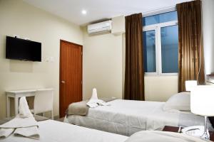 Posteľ alebo postele v izbe v ubytovaní LC Hoteles Piura