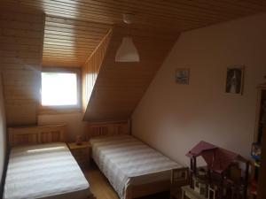 A bed or beds in a room at Nyaraló a Balaton parton
